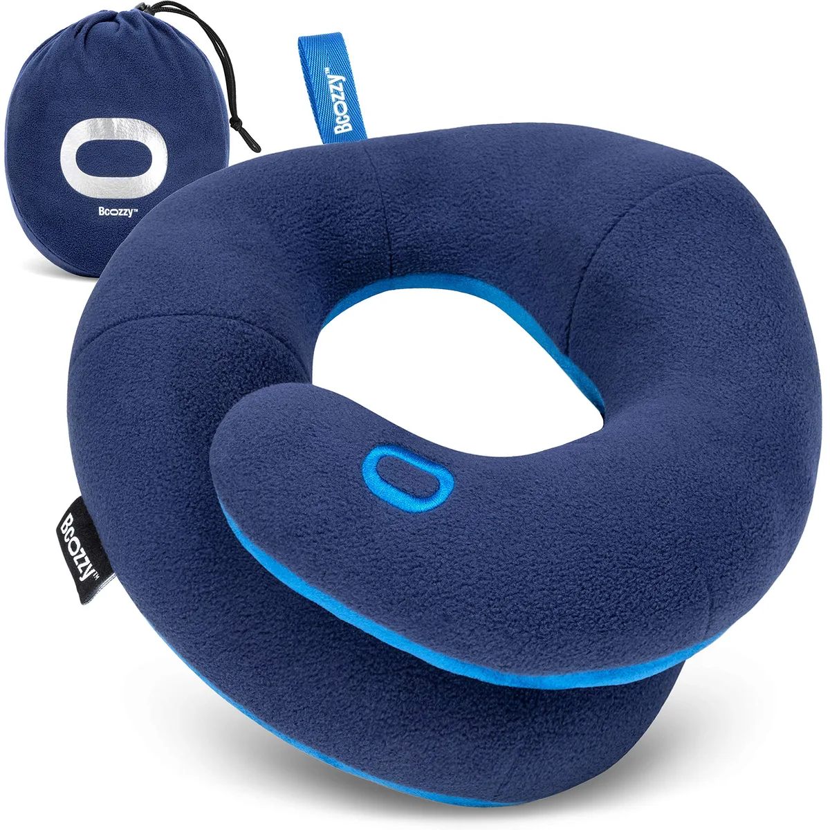 The navy blue BCOZZY travel neck pillow with its overlapping coil ends and matching carry bag