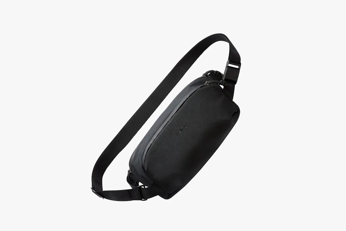The black Bellroy Venture Ready Sling 2.5L crossbody bag suspended by its webbing strap