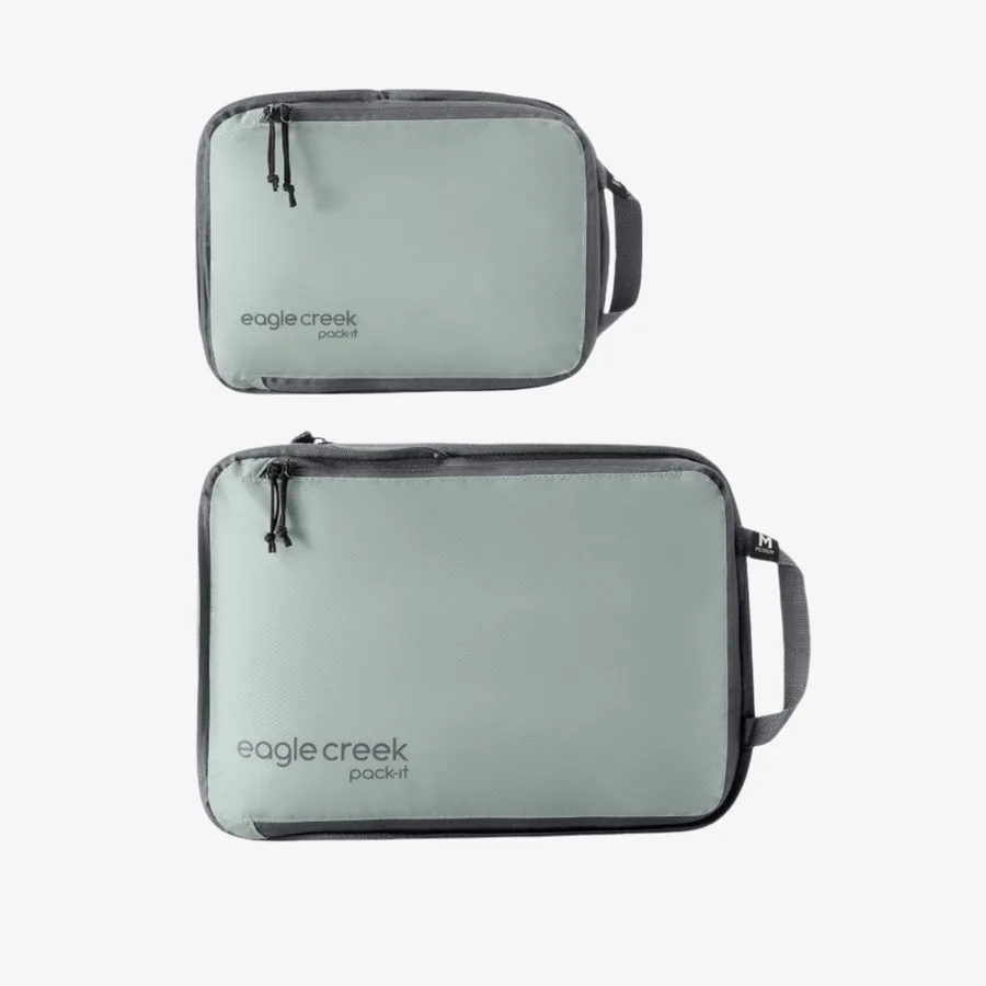 The Eagle Creek Pack-It Isolate Compression Cube Set in sage grey, a small and a medium cube shown from above
