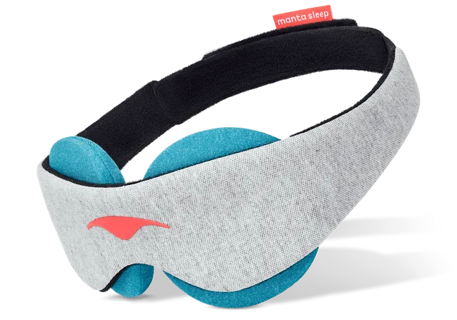 The Manta Cool Sleep Mask in grey with removable teal cooling eye cups and black straps