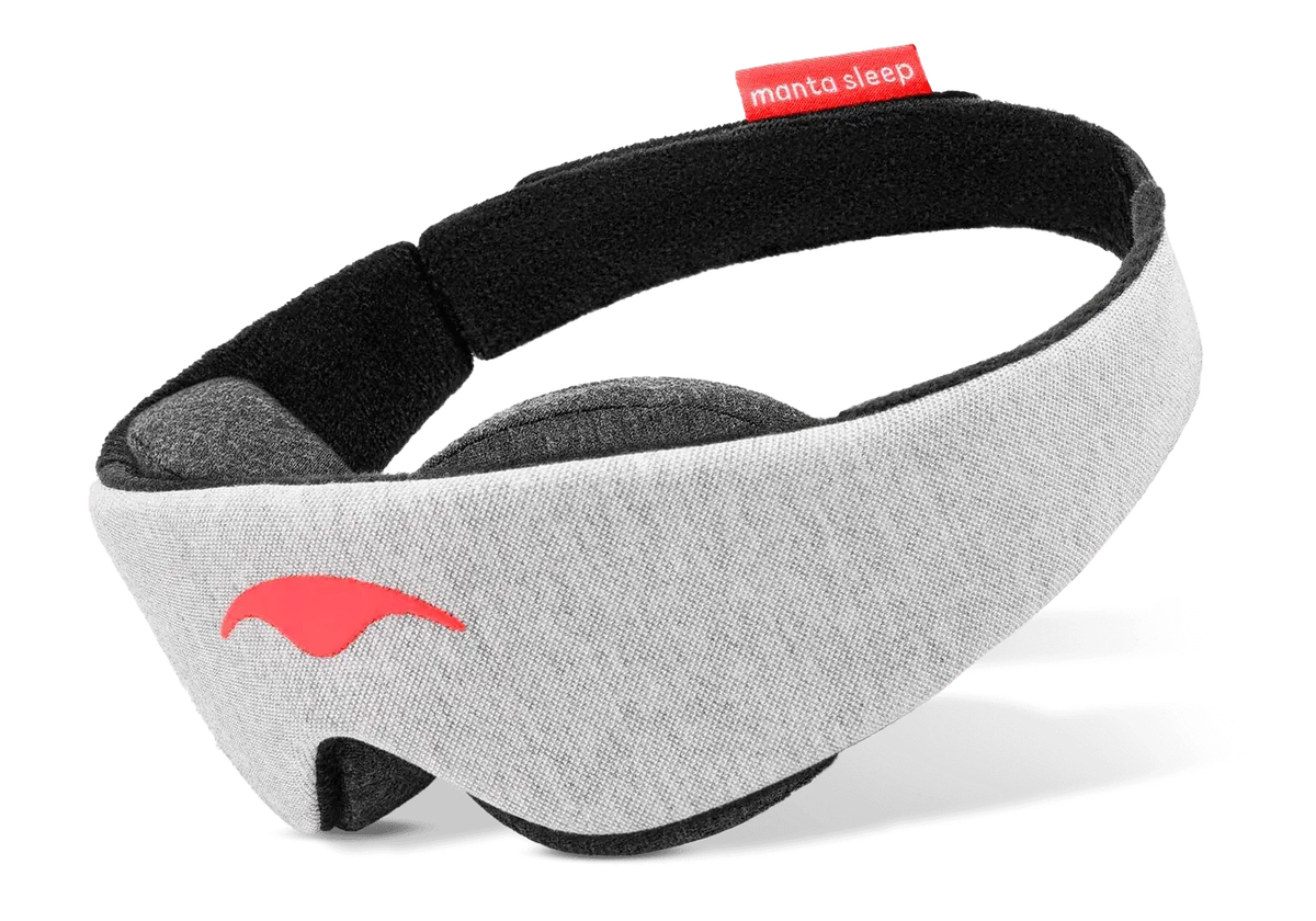The original Manta Sleep Mask, a grey contoured eye mask with black adjustable head straps and the orange Manta logo