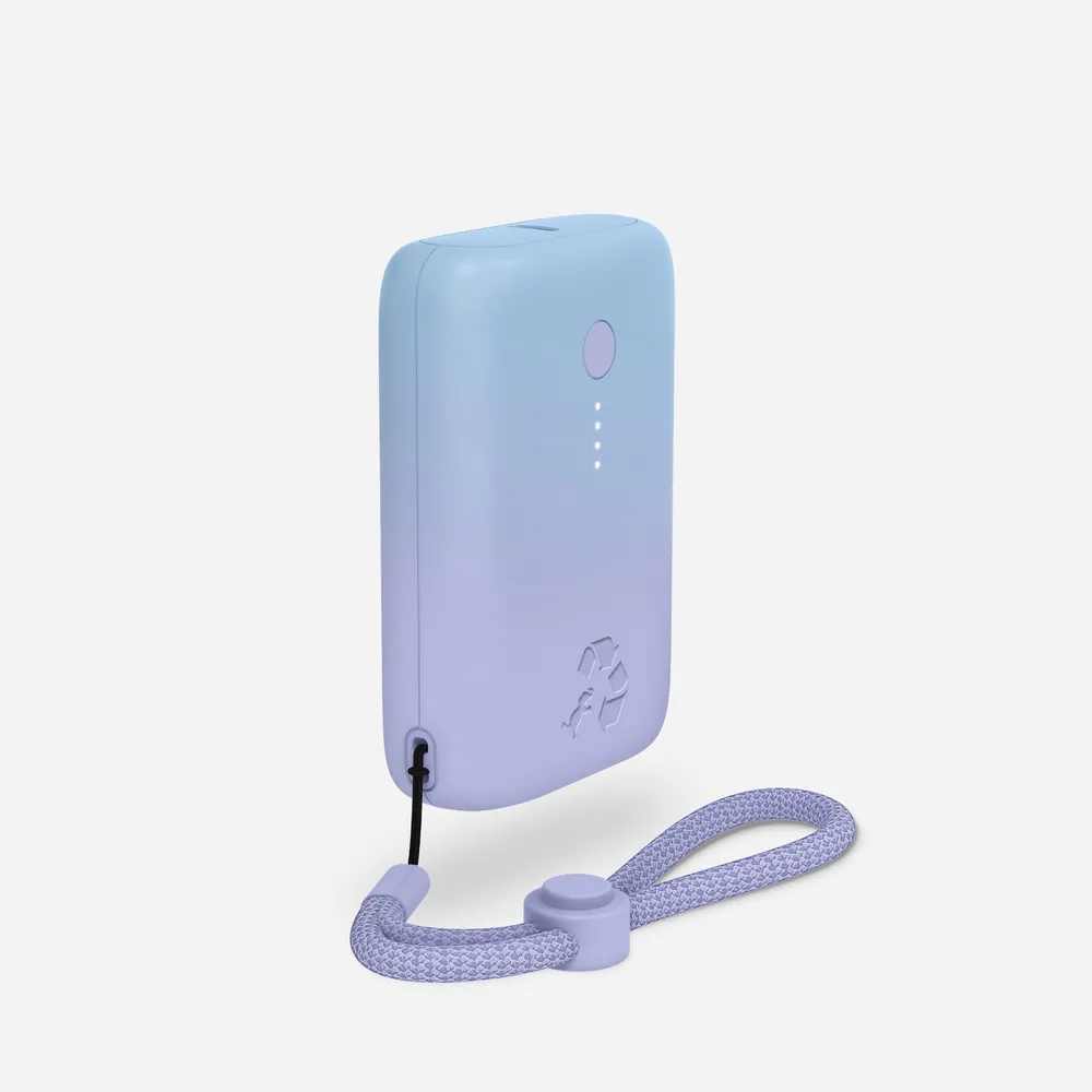 The Nimble Champ power bank in a blue-to-lavender gradient finish, with a recycled-materials logo, four LED dots, and a matching braided lanyard