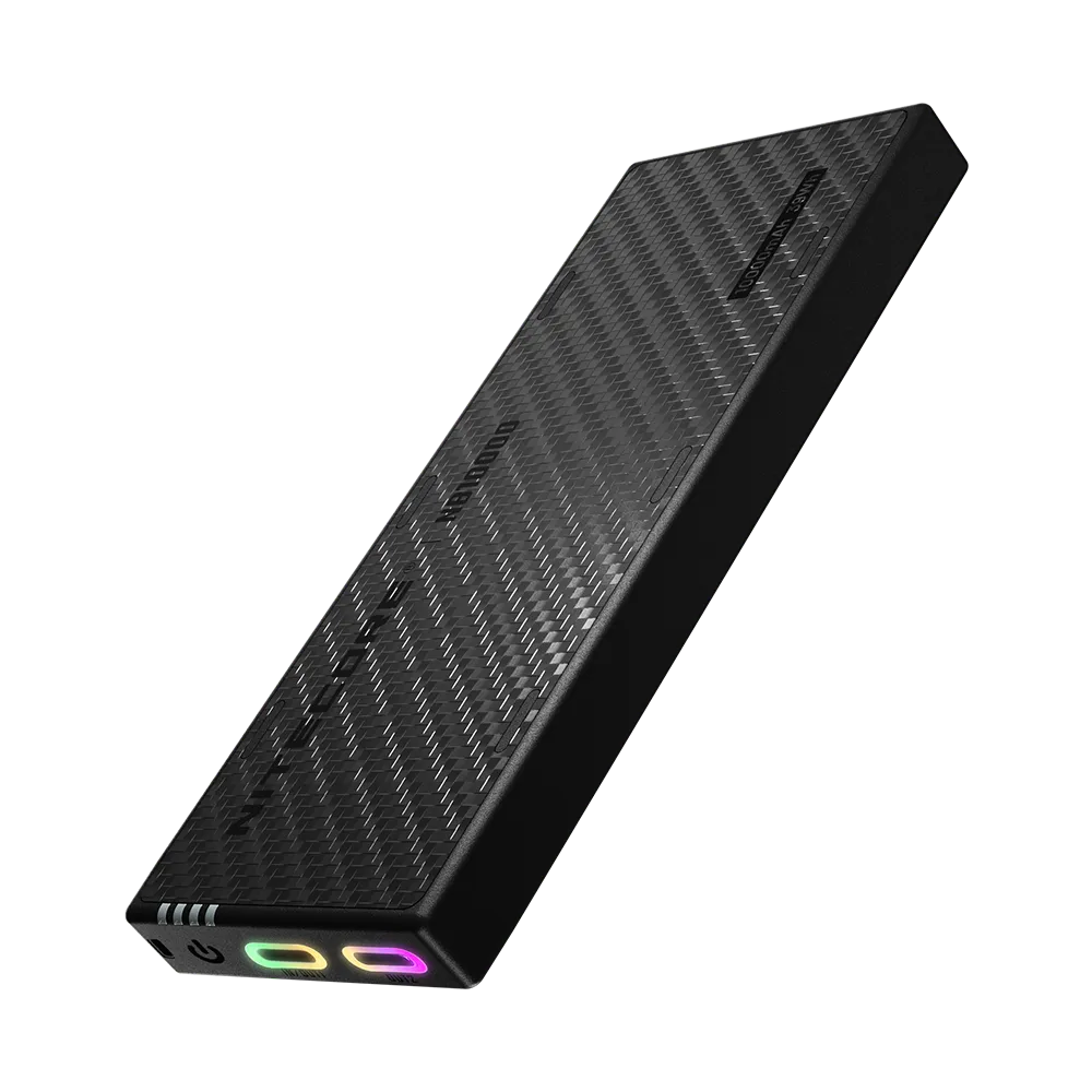 The Nitecore NB10000 Gen4 power bank in black, a slim carbon-textured slab with two illuminated USB-C ports glowing at one end
