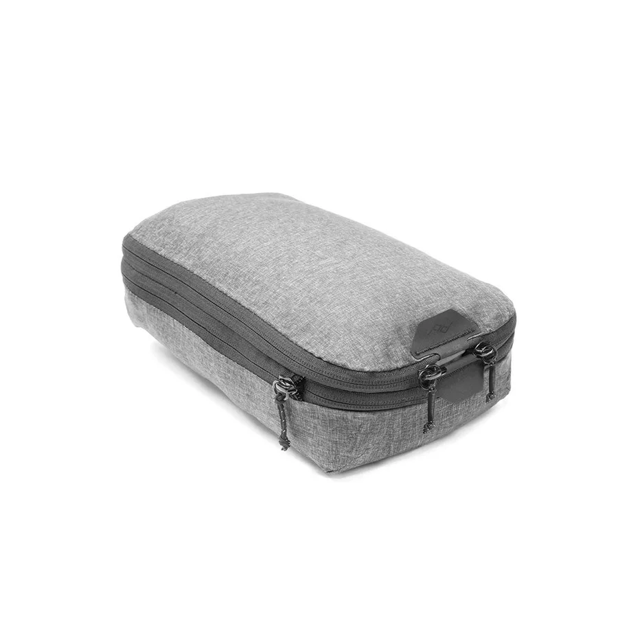 The Peak Design Packing Cube in charcoal, a compression packing cube with dual zippers and a leather-look pull tab