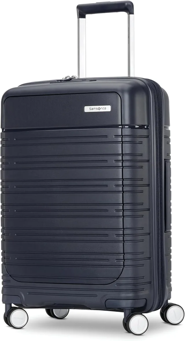 A Samsonite Elevation Plus hardside carry-on spinner in midnight blue, with a front quick-access compartment