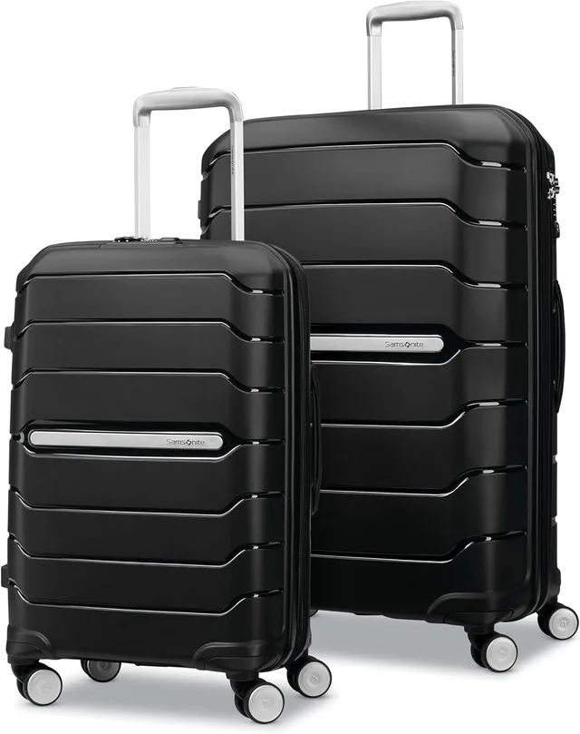 A two-piece Samsonite Freeform hardside spinner set in black, a carry-on beside a large checked bag with recessed spinner wheels