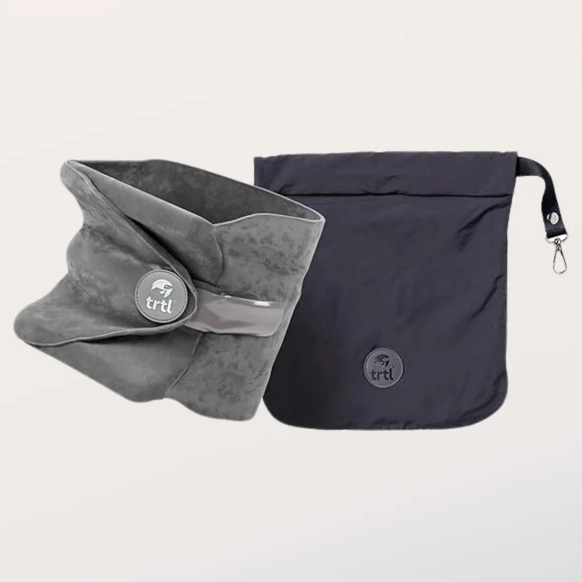 The grey Trtl Travel Pillow wrap with its fastener and dark drawstring travel bag