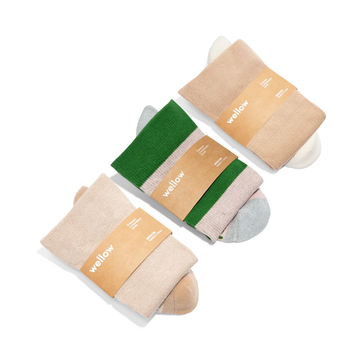 Three pairs of Wellow wide-calf compression socks in neutral tones with branded paper bands